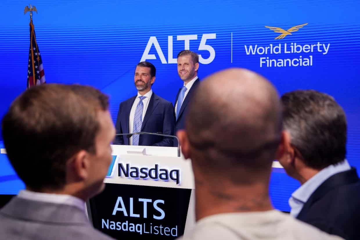 Two men side by side in front of a Nasdaq podium