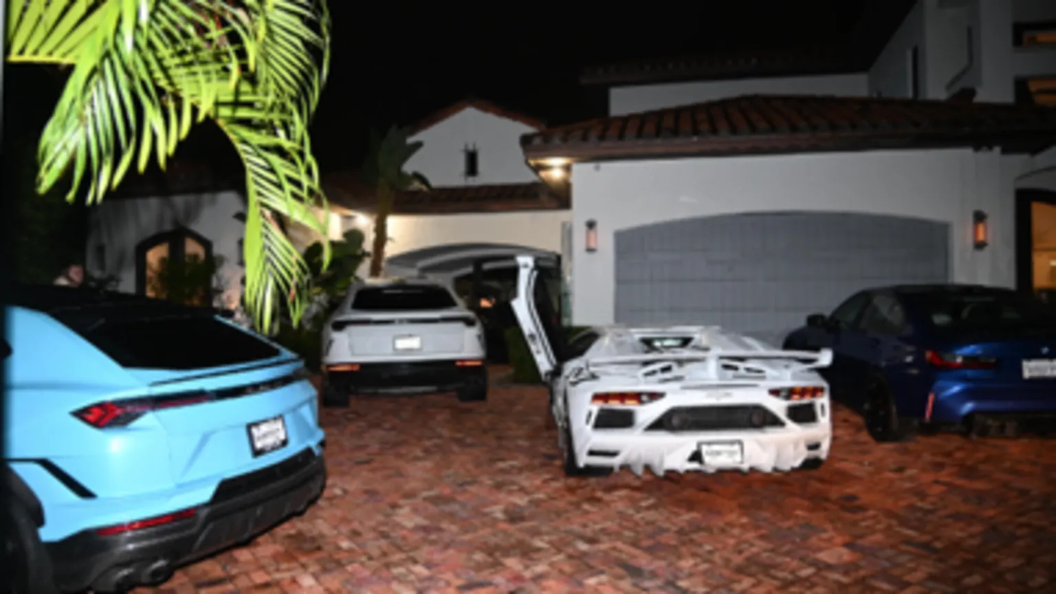 US Department of Justice Several supercars parked in the courtyard of a large villa